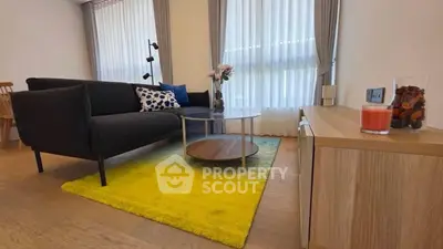 Modern living room with stylish furniture and bright yellow rug