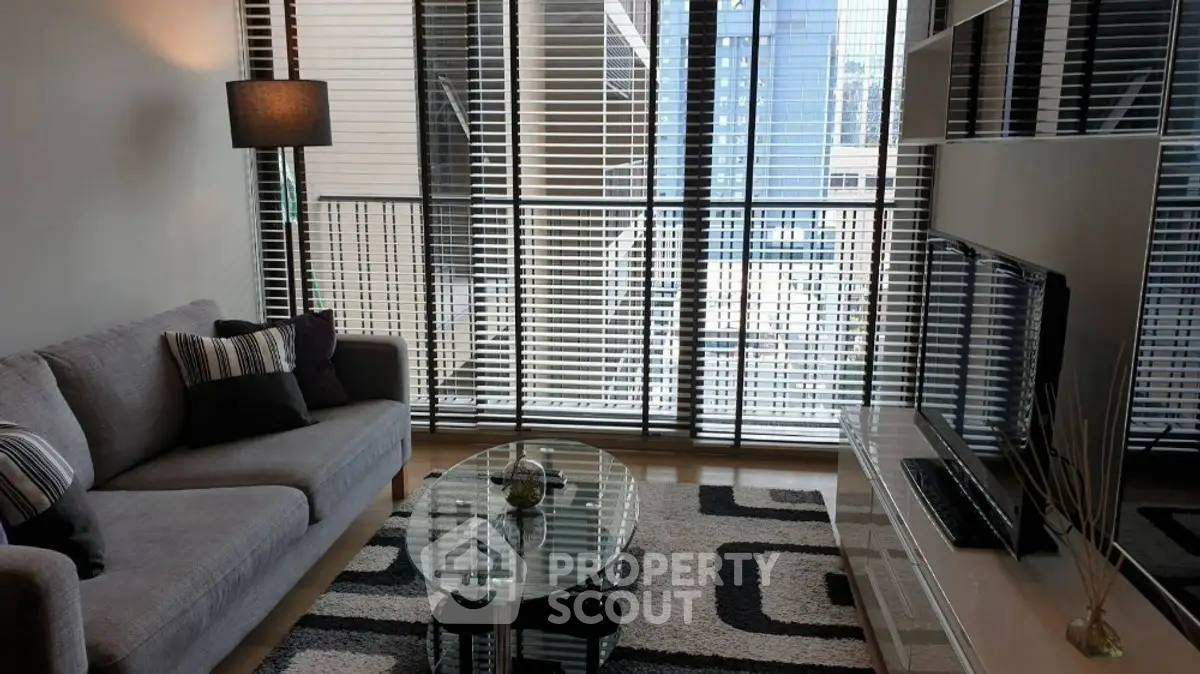 Modern living room with floor-to-ceiling windows and stylish decor