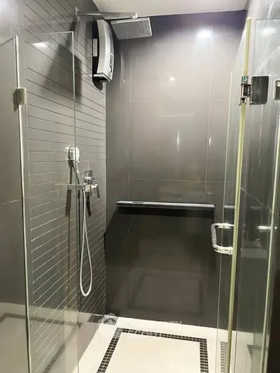 Modern bathroom with sleek glass shower enclosure and contemporary fixtures.