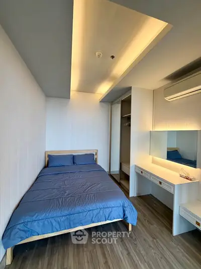 Modern bedroom with sleek design, featuring a cozy bed, built-in wardrobe, and stylish vanity area.