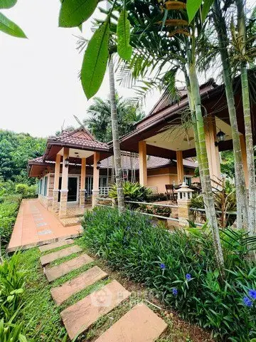 Charming tropical villa with lush garden and traditional architecture