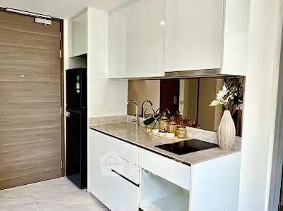 Modern kitchen with sleek white cabinets and built-in appliances