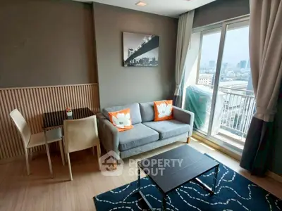 Modern living room with balcony and city view, featuring stylish decor and cozy seating area.