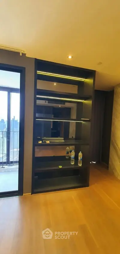 Modern apartment with sleek shelving and city view balcony, perfect for urban living.