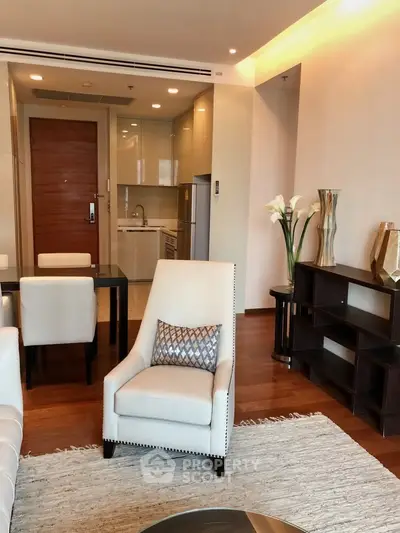 Modern living room with elegant furniture and open kitchen layout in a stylish apartment.