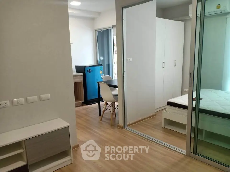 Modern studio apartment with wooden flooring and sliding glass doors