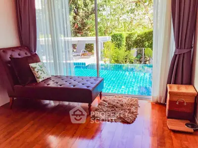 Luxurious room with pool view and elegant chaise lounge