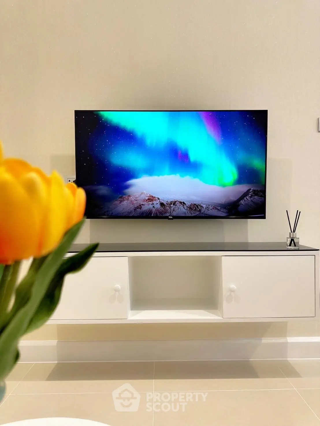 Modern living room with wall-mounted TV and vibrant decor