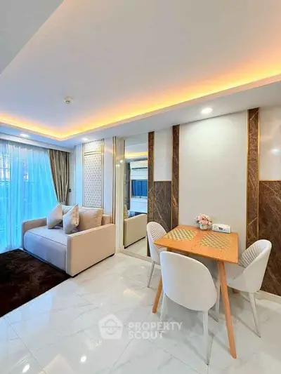 Modern living room with elegant decor and cozy seating area, featuring ambient lighting and stylish dining setup.