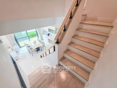 Modern duplex interior with elegant staircase and bright living area