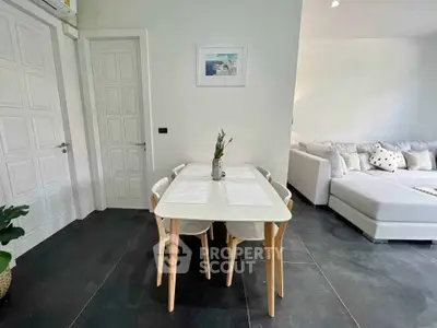 Modern living room with stylish dining area and cozy sofa, perfect for relaxation and entertaining.