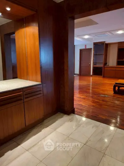 Spacious interior with wooden flooring and elegant cabinetry, perfect for modern living.