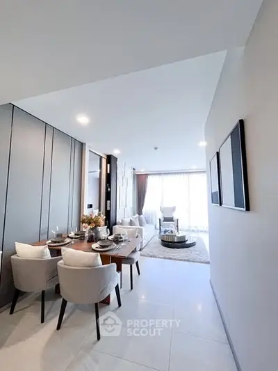 Modern open-plan living and dining area with elegant decor and natural light.