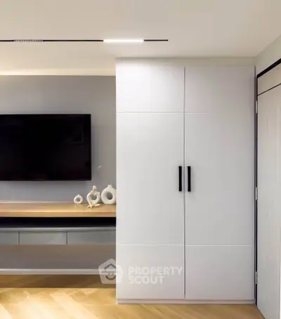 Modern living room with sleek storage and wall-mounted TV