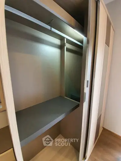 Spacious walk-in closet with modern sliding doors and ample storage space.