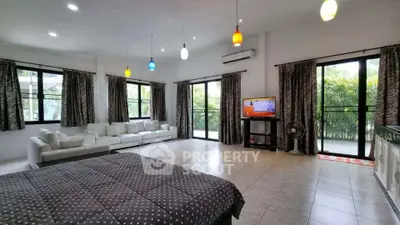 Spacious modern living room with large windows and stylish lighting