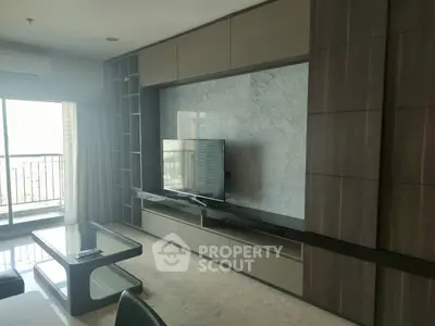 Spacious living room with modern TV unit and balcony view