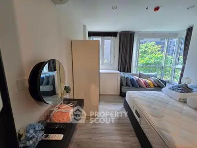 Bright and cozy bedroom with large windows and modern decor