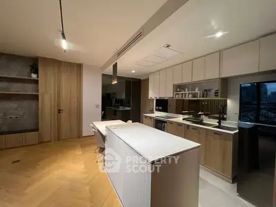 Modern kitchen with sleek cabinetry and island in open layout apartment