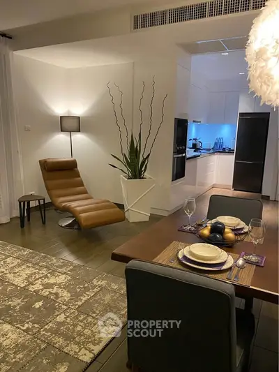 Modern open-plan living and dining area with stylish decor and kitchen view