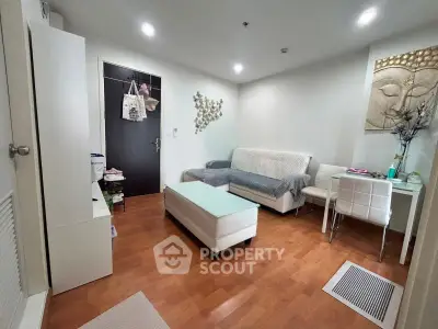 Modern living room with stylish decor and hardwood floors in a cozy apartment.