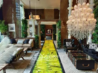 Luxurious living room with opulent chandelier and unique green carpet