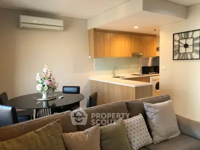 Modern open-plan living room with cozy seating and stylish kitchen