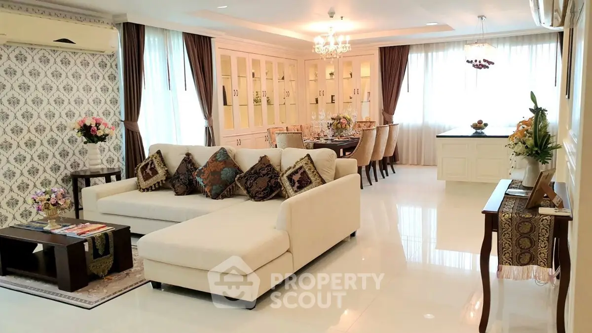Luxurious open-plan living and dining area with elegant decor and ample natural light.