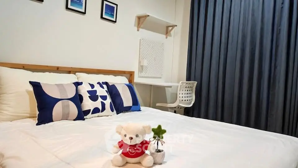 Cozy bedroom with modern decor and plush teddy bear on bed
