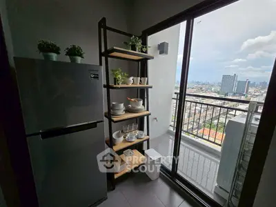 Modern kitchen with balcony view, featuring sleek fridge and stylish shelving unit.