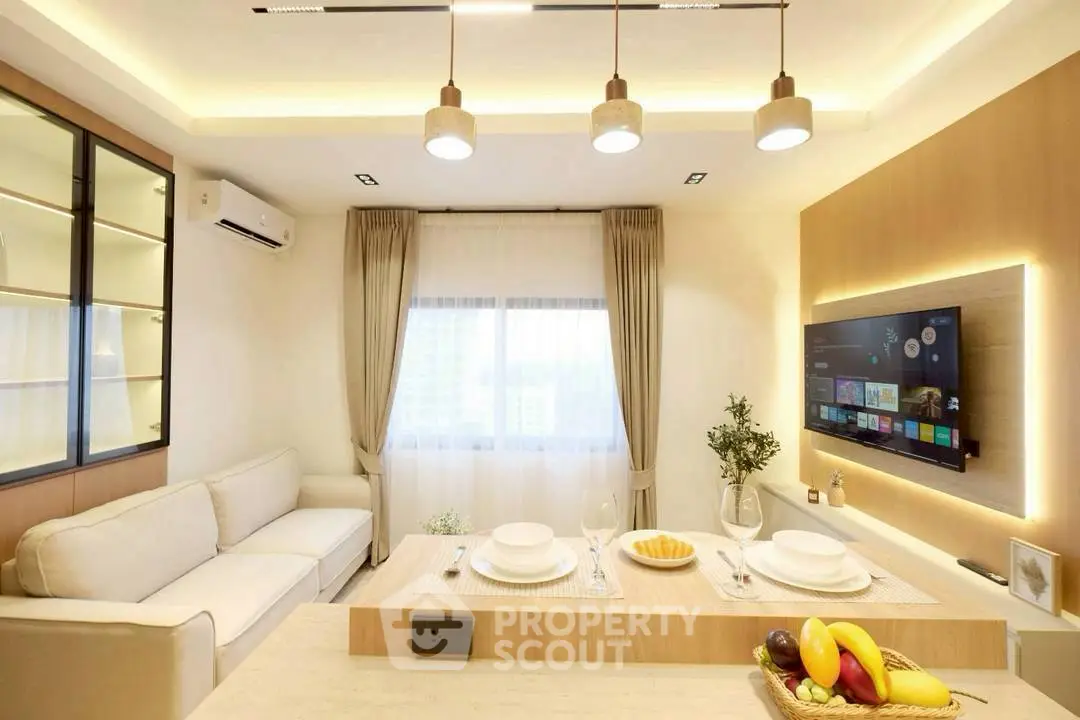 Modern living room with cozy sofa, stylish lighting, and wall-mounted TV for ultimate relaxation.
