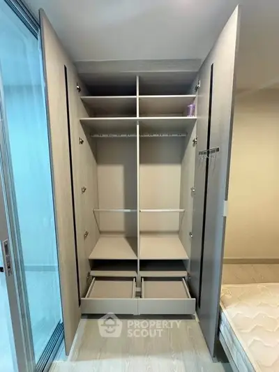 Spacious modern wardrobe with sliding doors in a stylish bedroom setting.