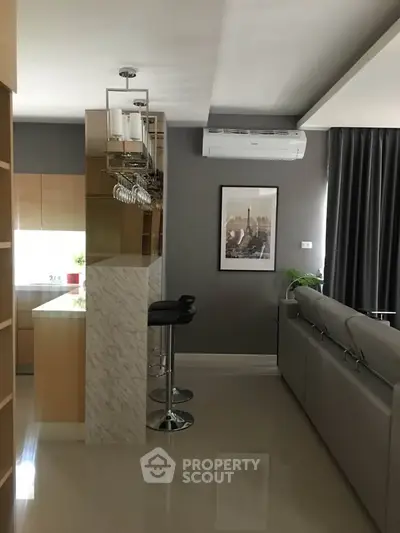 Modern living room with sleek kitchen bar and stylish decor