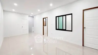 Spacious and bright empty room with modern finishes and sleek design, perfect for customization.