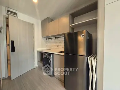Modern kitchen with sleek appliances and open shelving in a compact layout