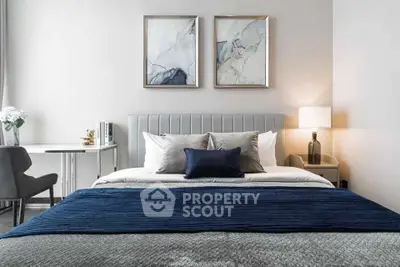 Modern bedroom with elegant decor and cozy bedding in a stylish apartment.