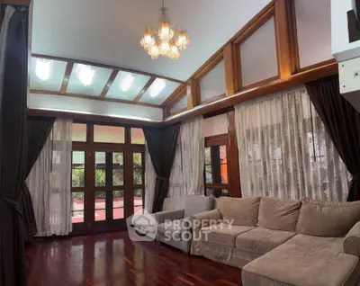 Spacious living room with elegant wooden accents and large windows for natural light.