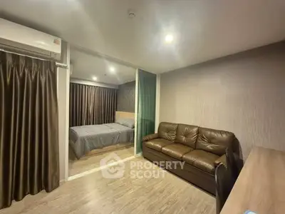 Modern apartment interior with cozy living room and bedroom, featuring sleek design and comfortable furnishings.