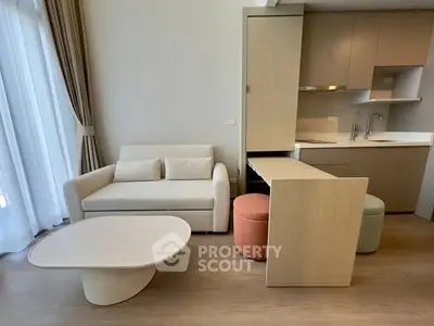 Modern living room with compact kitchen and stylish furniture