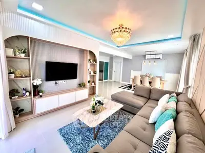 Luxurious living room with elegant chandelier and modern decor, featuring a spacious sectional sofa and stylish TV unit.
