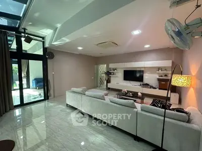 Spacious modern living room with sleek design and large windows for natural light.