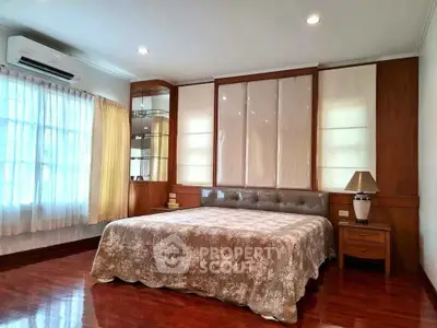 Spacious bedroom with elegant decor and large windows for natural light