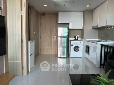 Modern kitchen with sleek appliances and washing machine in stylish apartment