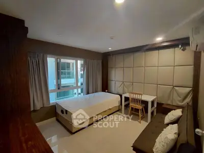 Cozy bedroom with modern decor and ample natural light