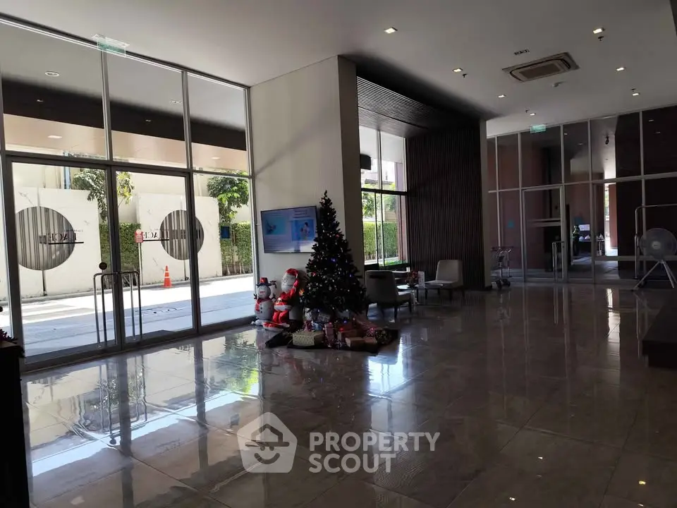Spacious modern building entrance with Christmas decorations and glass doors