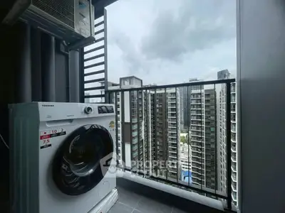 Modern balcony with washing machine and cityscape view in high-rise apartment