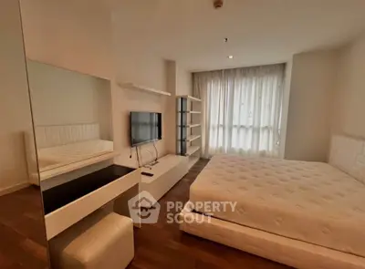 Modern bedroom with stylish furniture and natural light in a luxury apartment.