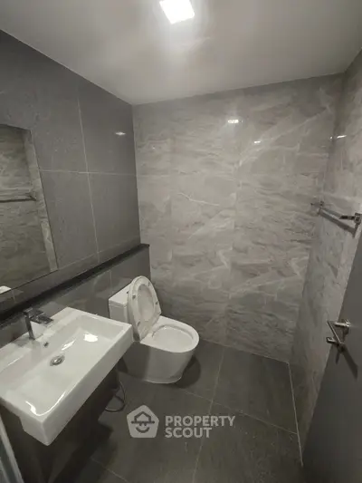 Modern bathroom with sleek gray tiles and contemporary fixtures