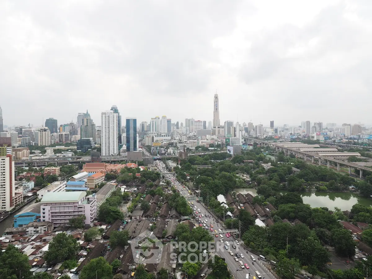 Stunning cityscape view showcasing urban skyline and lush greenery, perfect for real estate investment.