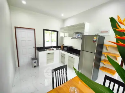 Modern kitchen with sleek cabinets and stainless steel appliances in a bright, open space.